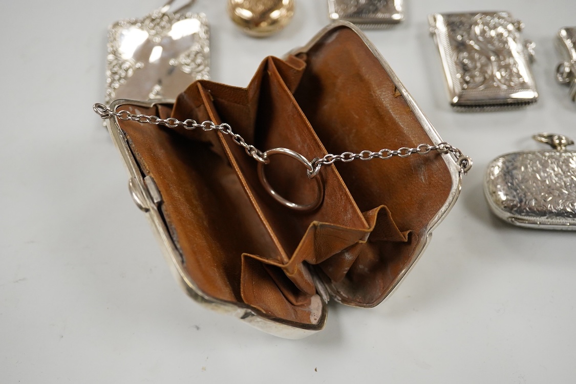 Two late Victorian silver twin compartment sovereign cases, Birmingham, 1891 & 1896, both approx. 57mm, a gold plated sovereign case, together with three silver vesta cases, a silver purse and a silver mounted notebook.